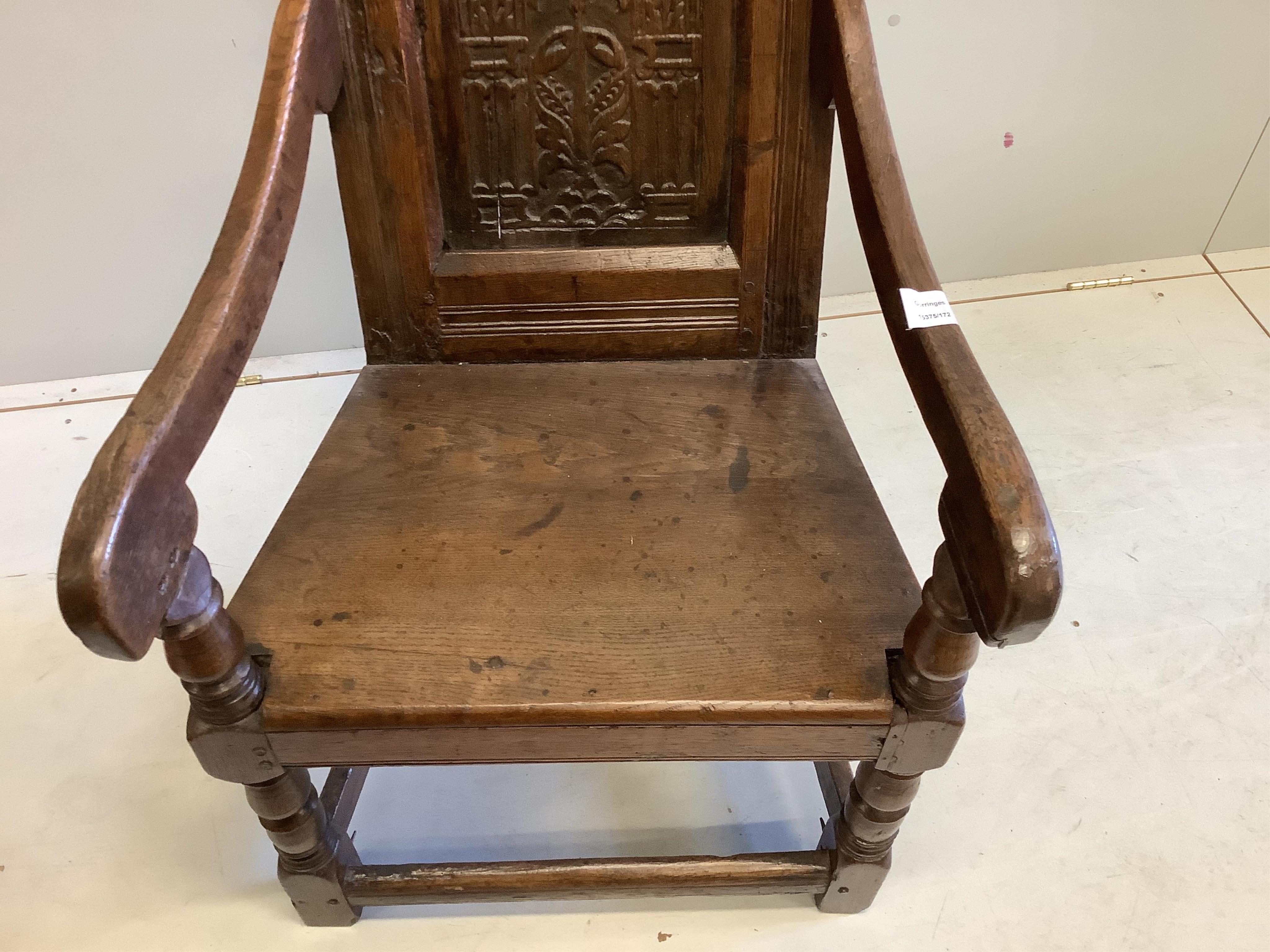 A 17th century carved oak wainscot elbow chair, width 57cm, depth 52cm, height 105cm. Condition - fair